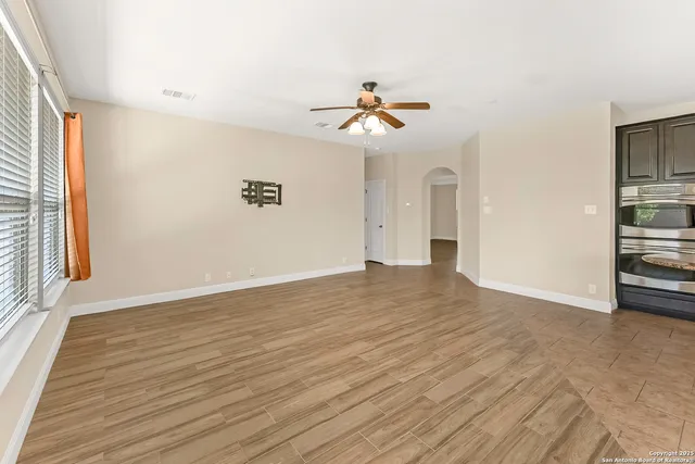 wooden floor in an empty room with a window