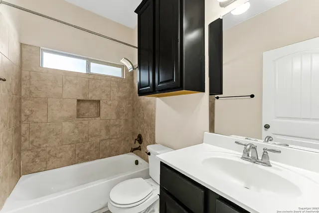 a bathroom with a sink a toilet and bathtub