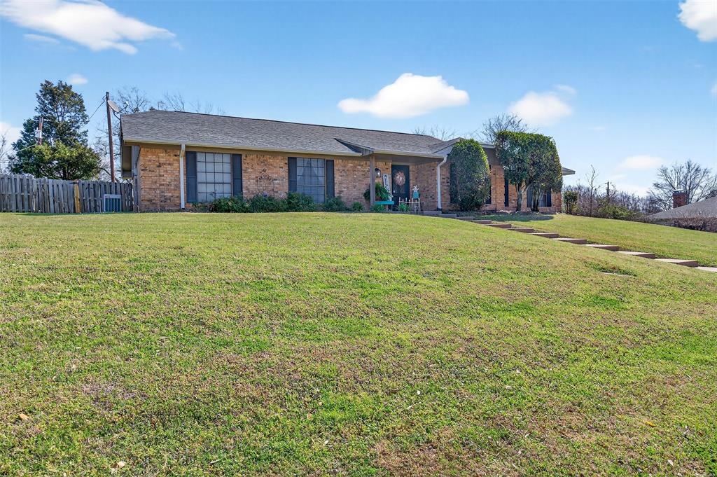 209 Colonial Circle Athens, TX 75751 - Photo 3 of 22 a view of a house with a yard and potted plants