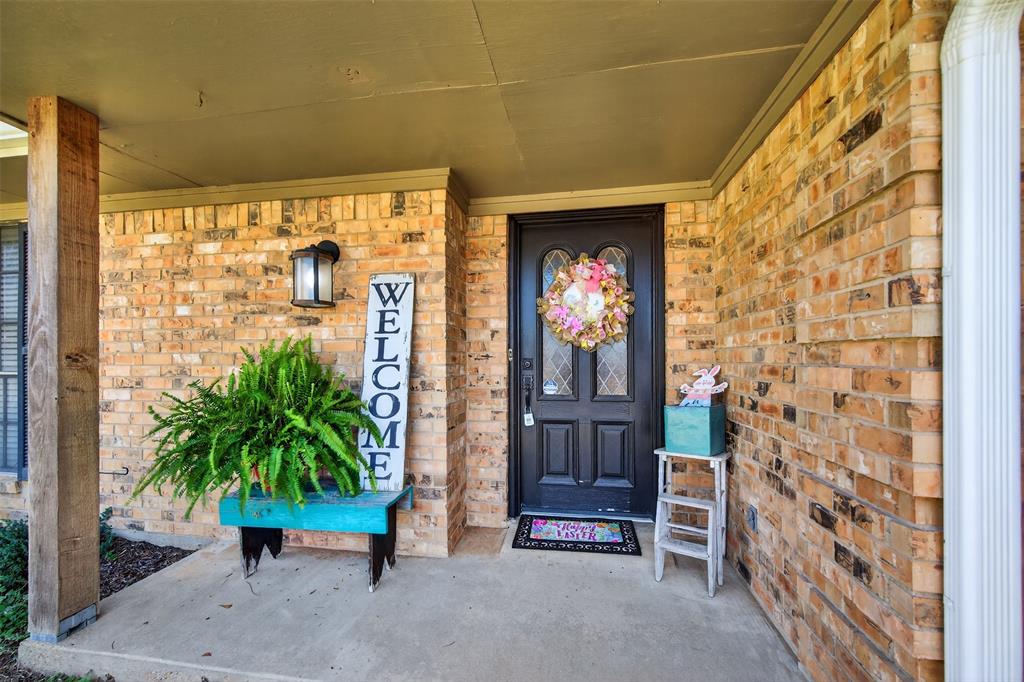 209 Colonial Circle Athens, TX 75751 - Photo 4 of 22 a potted plant in front of a door