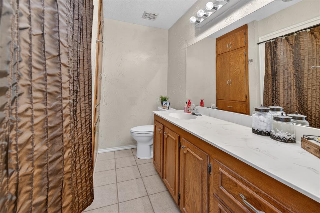 209 Colonial Circle Athens, TX 75751 - Photo 6 of 22 a bathroom with a double vanity sink toilet and a mirror