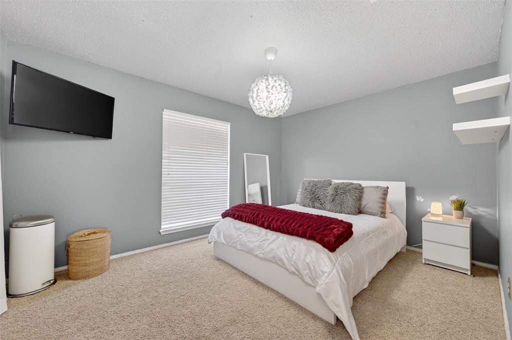 209 Colonial Circle Athens, TX 75751 - Photo 7 of 22 a spacious bedroom with a bed and a flat screen tv