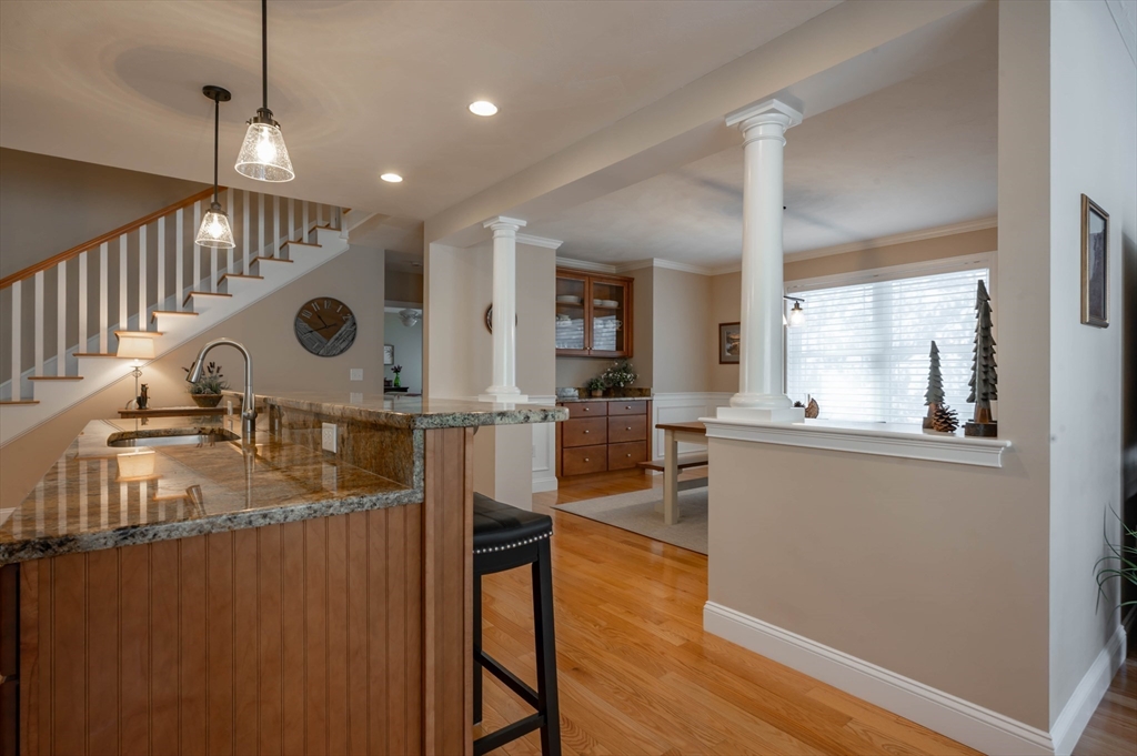 9 Pilgrim Circle Nashua, NH 03063 - Photo 11 of 39 a open kitchen with stainless steel appliances granite countertop a stove and a wooden floors