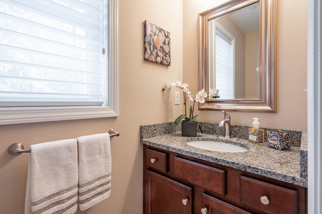 9 Pilgrim Circle Nashua, NH 03063 - Photo 18 of 39 a bathroom with a granite countertop sink and a mirror