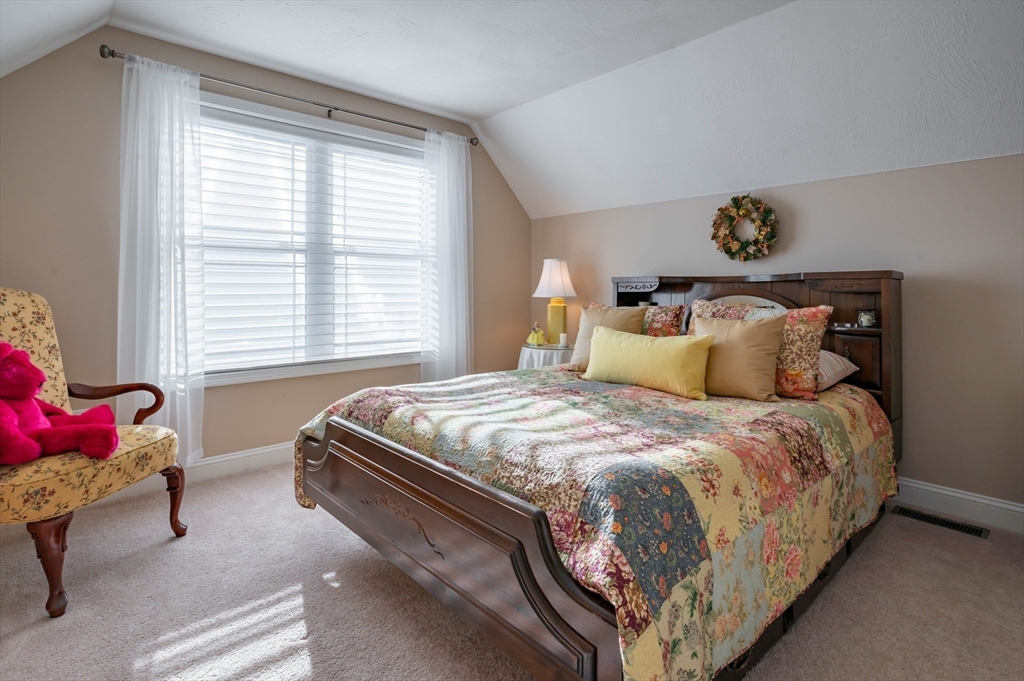 9 Pilgrim Circle Nashua, NH 03063 - Photo 23 of 39 a bed sitting in a bedroom next to a window