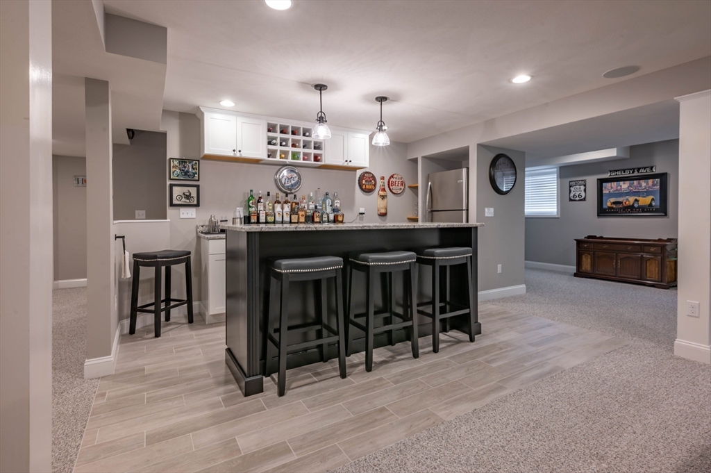 9 Pilgrim Circle Nashua, NH 03063 - Photo 26 of 39 a large kitchen with a table and chairs in it