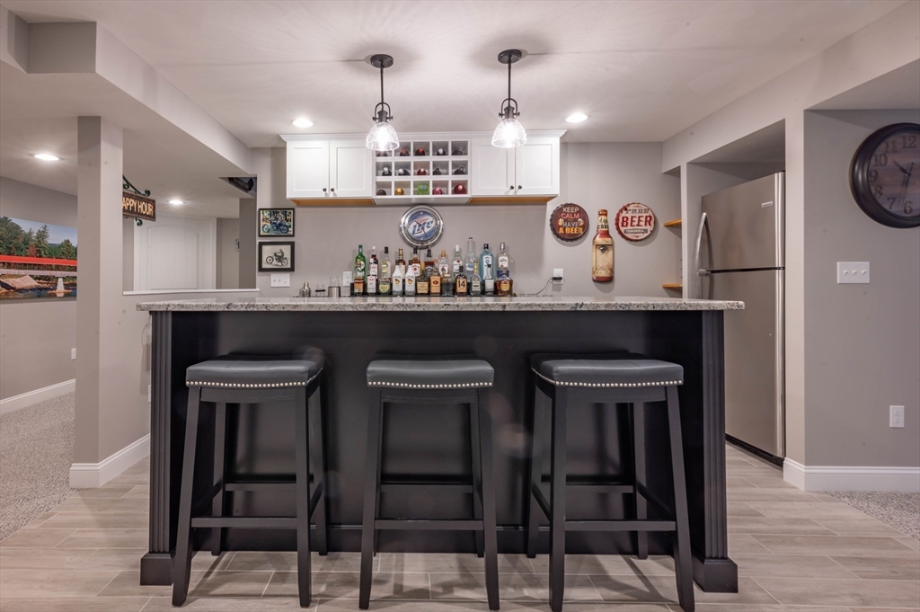 9 Pilgrim Circle Nashua, NH 03063 - Photo 27 of 39 a view of a kitchen with a table and chairs in it
