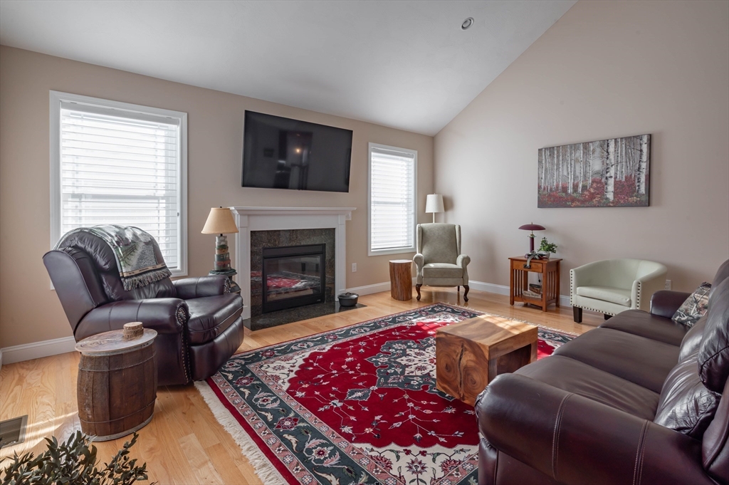 9 Pilgrim Circle Nashua, NH 03063 - Photo 3 of 39 a living room with furniture or couch and a fireplace