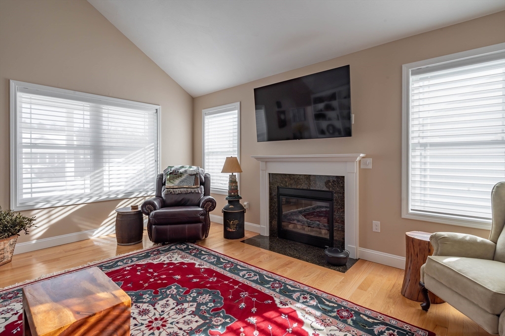 9 Pilgrim Circle Nashua, NH 03063 - Photo 4 of 39 a living room with furniture and a fireplace