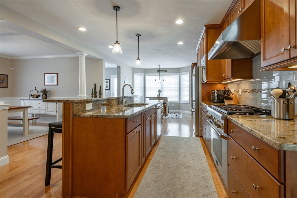9 Pilgrim Circle Nashua, NH 03063 - Photo 6 of 39 a kitchen with stainless steel appliances granite countertop a sink a stove and a refrigerator
