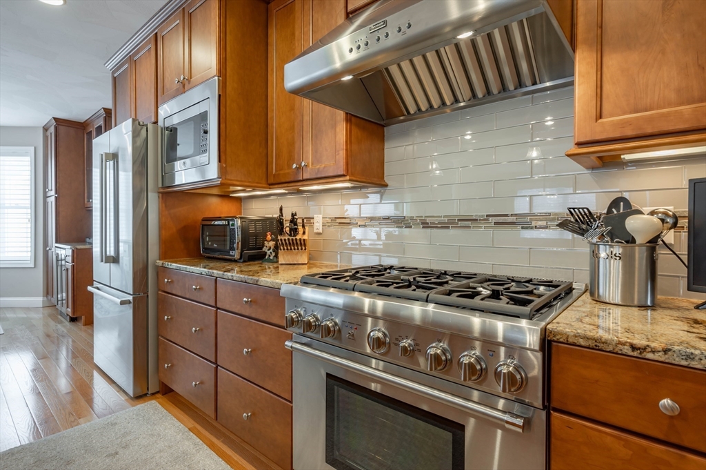 9 Pilgrim Circle Nashua, NH 03063 - Photo 8 of 39 a kitchen with granite countertop stainless steel appliances and wooden cabinets
