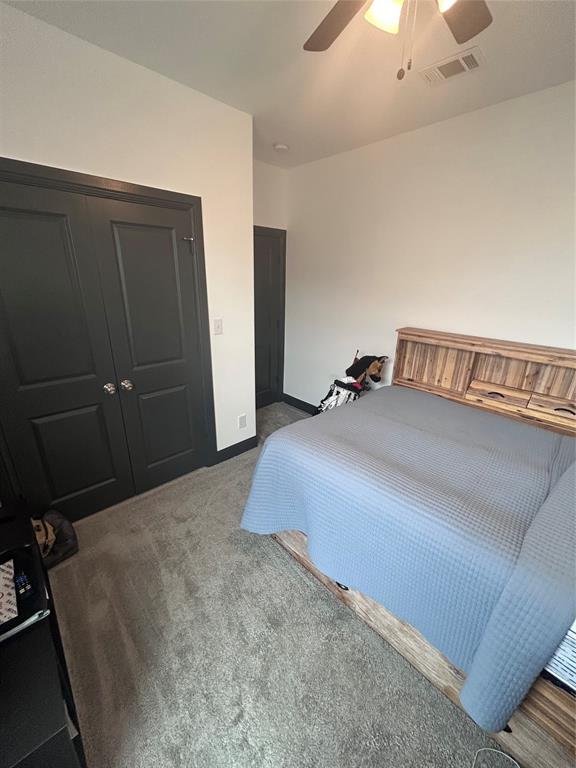 324 Bronco Drive Pilot Point, TX 76258 - Photo 12 of 17 a bedroom with a bed and a chandelier