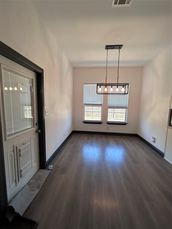 324 Bronco Drive Pilot Point, TX 76258 - Photo 9 of 17 an empty room with wooden floor staircase and windows