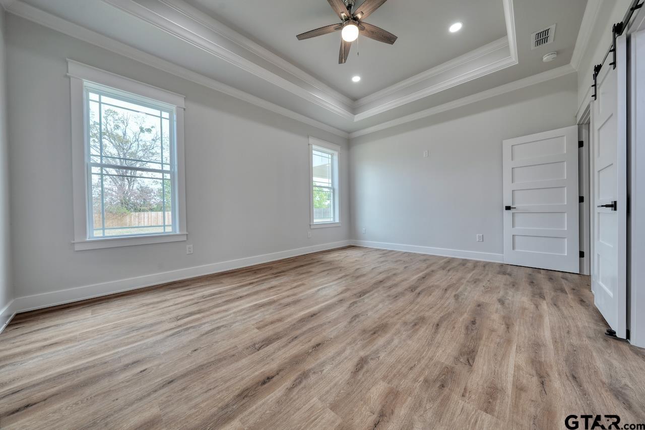 19383 Ridge Point Circle Lindale, TX 75771 - Photo 23 of 48 wooden floor in an empty room with a window