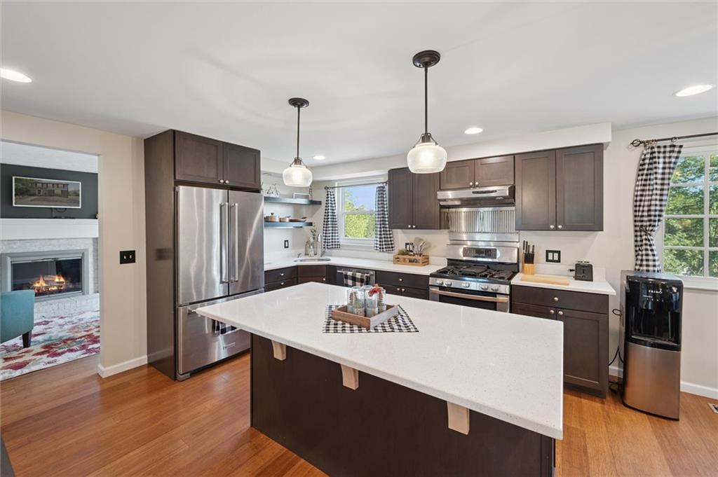 129 Kings Drive Monaca, PA 15061 - Photo 11 of 36 a kitchen with kitchen island granite countertop a sink stove and refrigerator