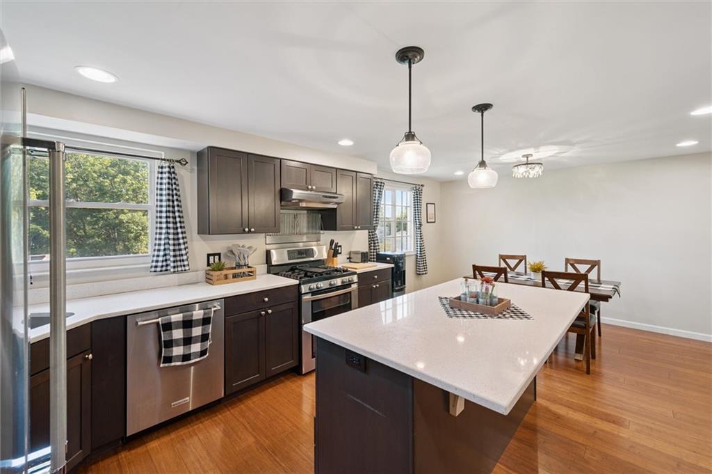 129 Kings Drive Monaca, PA 15061 - Photo 12 of 36 a kitchen with kitchen island a sink appliances and a counter top space