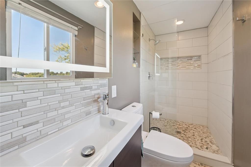 129 Kings Drive Monaca, PA 15061 - Photo 18 of 36 a bathroom with a sink a toilet and shower