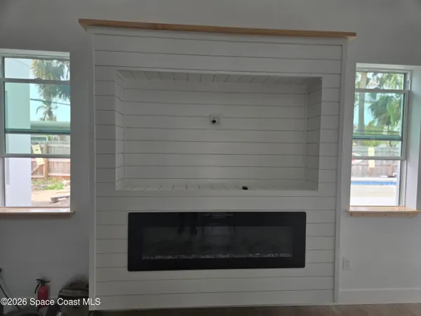 a living room with a fireplace and a window