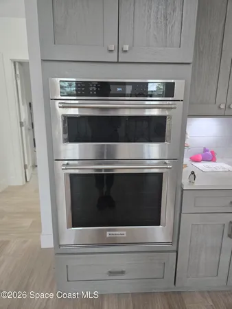 a stove top oven sitting inside of a kitchen