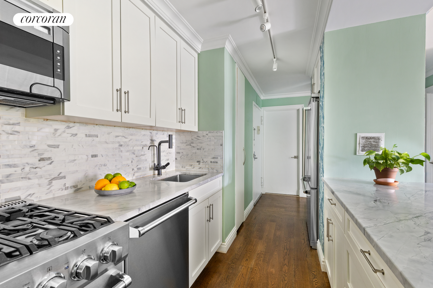 625 Main Street, Unit 643 Manhattan, NY 10044 - Photo 4 of 15 a kitchen with stainless steel appliances granite countertop a stove a sink and a microwave