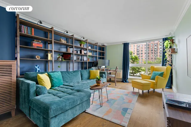 a living room with furniture and a book shelf