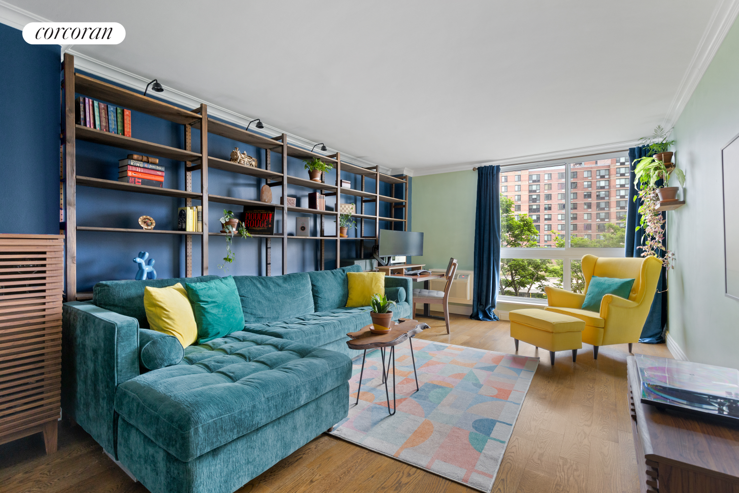 625 Main Street, Unit 643 Manhattan, NY 10044 - Photo 6 of 15 a living room with furniture and a book shelf