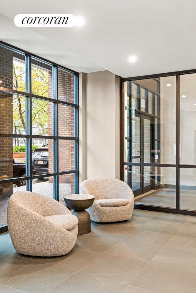 625 Main Street, Unit 643 Manhattan, NY 10044 - Photo 9 of 15 a bedroom with furniture and large window