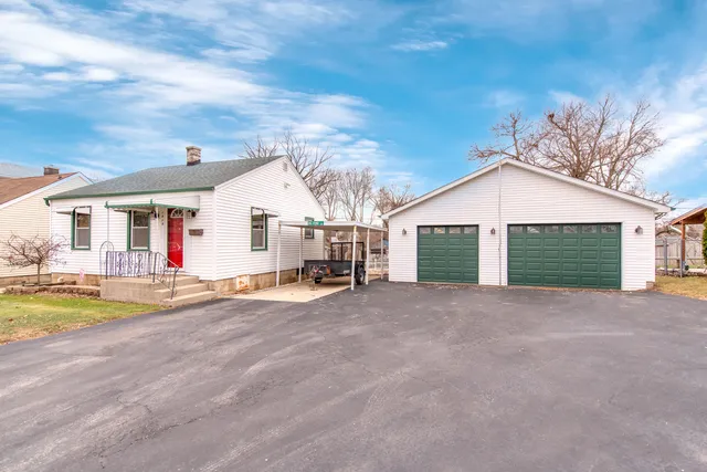 a view of a house with swimming pool and a yard
