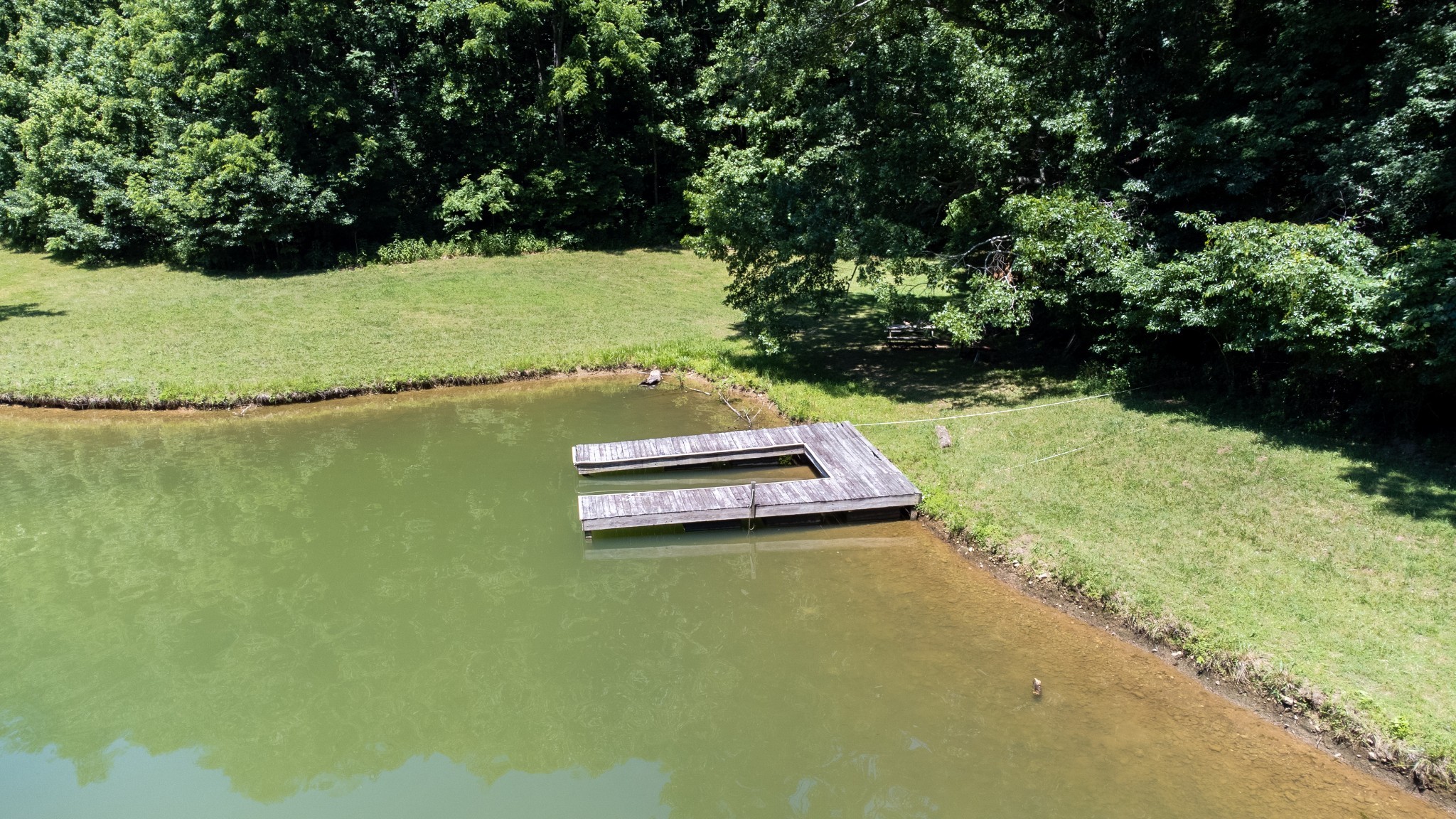 0 Turkey Creek Boat Dock Road Tullahoma, TN 37388 - Photo 12 of 39 a view of a lake with lawn chairs and large trees