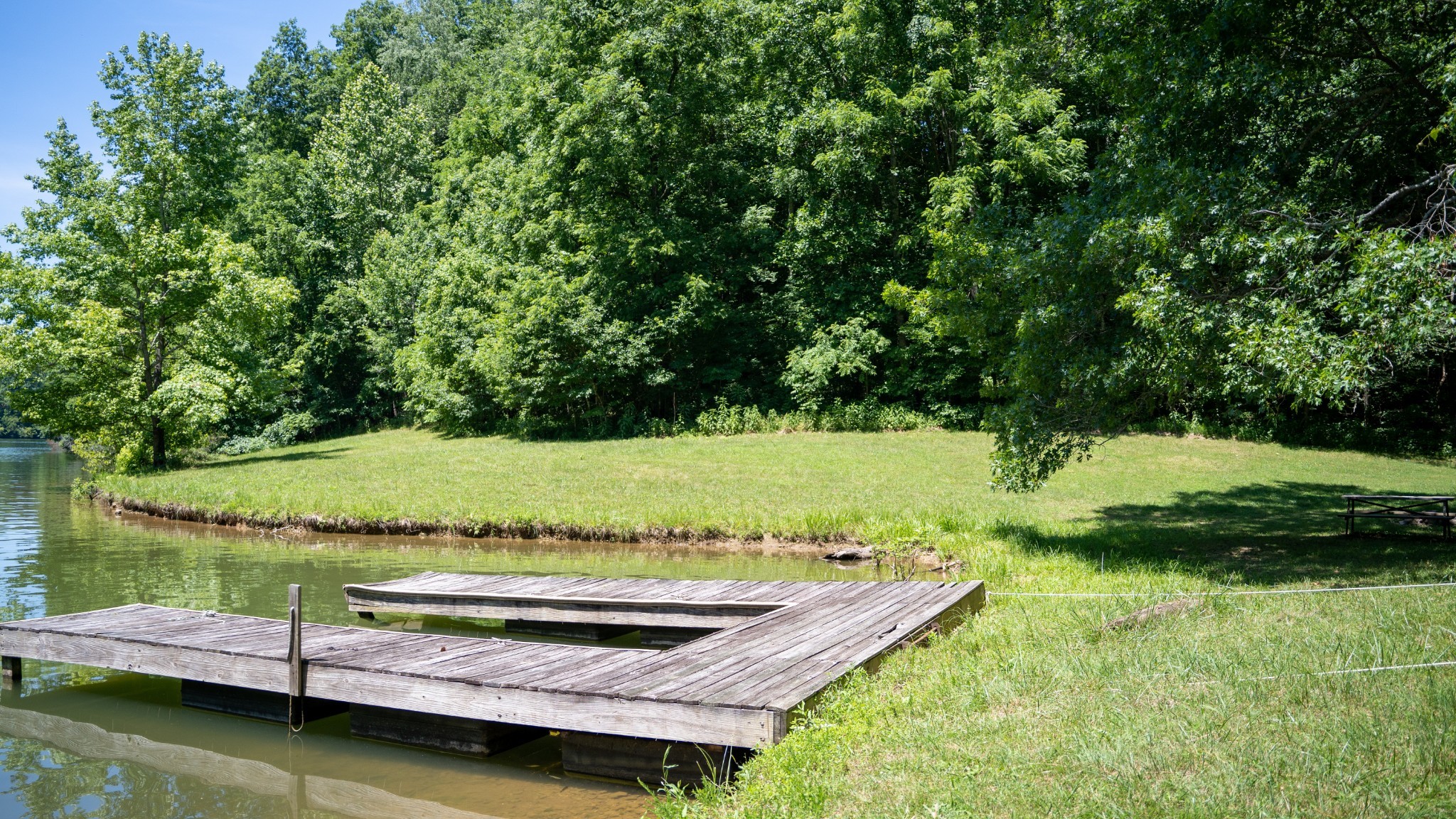 0 Turkey Creek Boat Dock Road Tullahoma, TN 37388 - Photo 31 of 39 a view of a lake with a yard and large trees