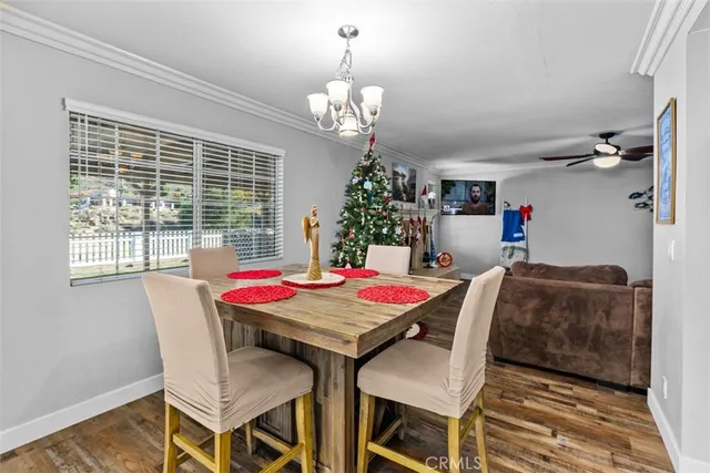 a dining room with furniture a chandelier and window