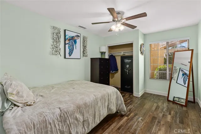 a bedroom with a bed and a ceiling fan