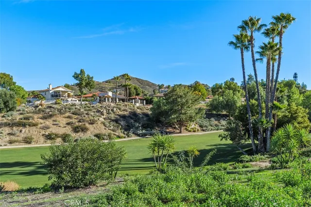 a view of a garden with a building in the background
