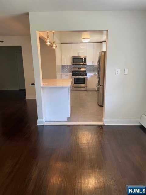 280-320 Oak Street, Unit 290D Ridgewood, NJ 07450 - Photo 7 of 20 a kitchen with stainless steel appliances a refrigerator and a stove