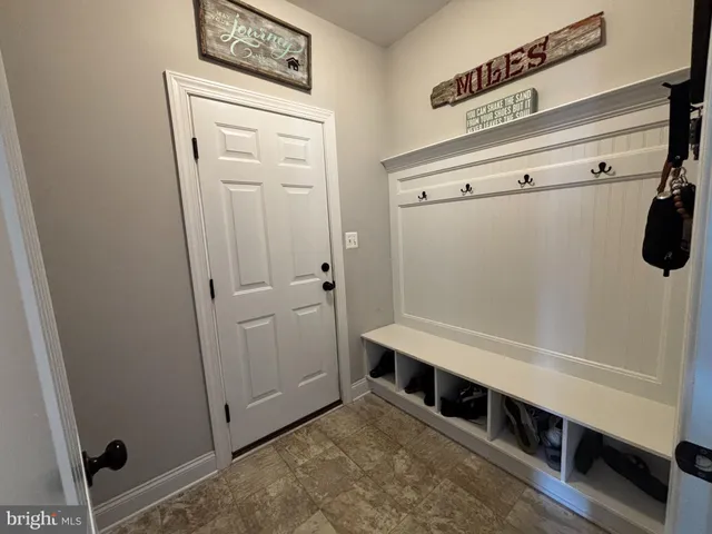 a kitchen with stainless steel appliances granite countertop a stove a refrigerator a kitchen island a table and chairs