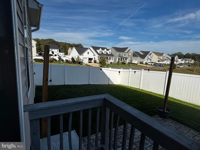 a bedroom with a bed a flat screen tv and guitar