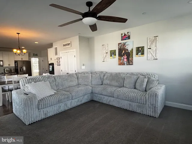 a spacious bedroom with a bed and a chandelier