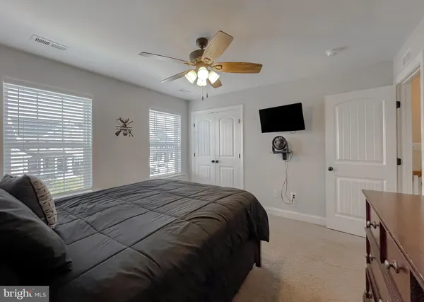 a spacious bedroom with a bed and a chandelier
