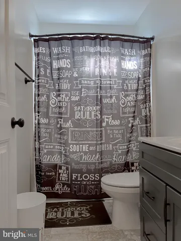 a bedroom with a large bed and a flat tv screen