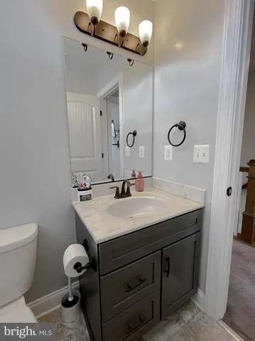 a spacious bedroom with a bed and a chair