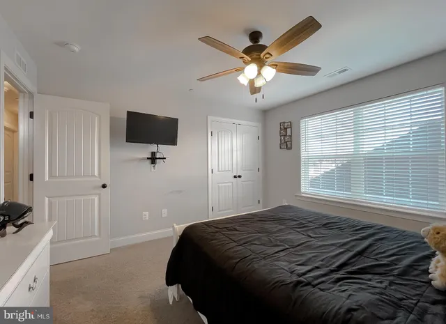 a bedroom with a large bed and a window