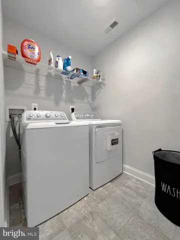 a spacious bedroom with a bed and a chandelier