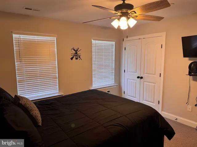 a view of a livingroom with wooden floor and stairs