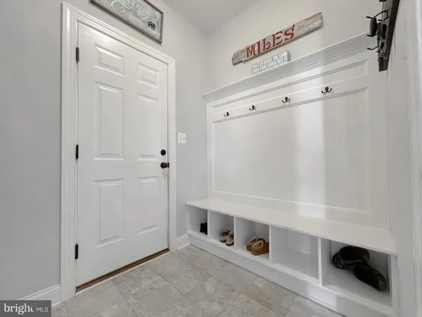 a view of staircase with lots of frames on wall and windows
