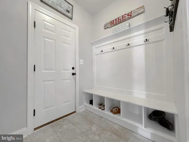 a living room with furniture and a dining table with wooden floor