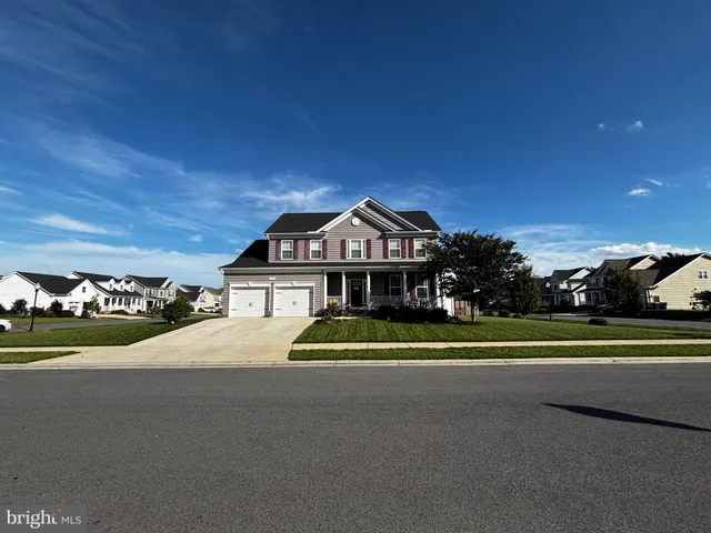 a front view of a house with a yard and outdoor seating