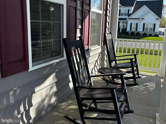 a kitchen with stainless steel appliances granite countertop a stove top oven a sink dishwasher a dining table and chairs with wooden floor