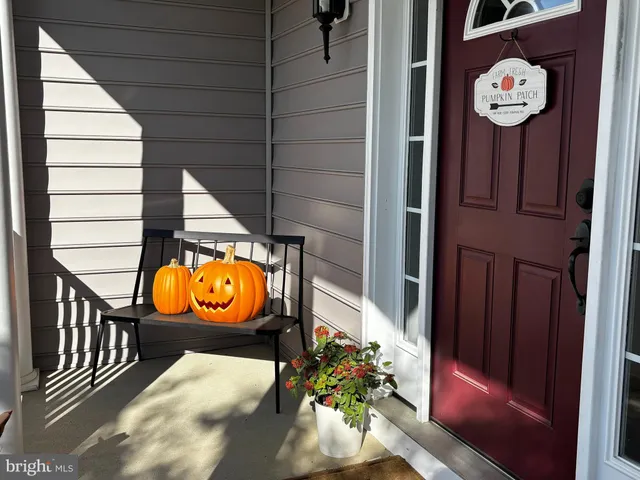 a kitchen with stainless steel appliances granite countertop a stove top oven a sink dishwasher a dining table and chairs with wooden floor