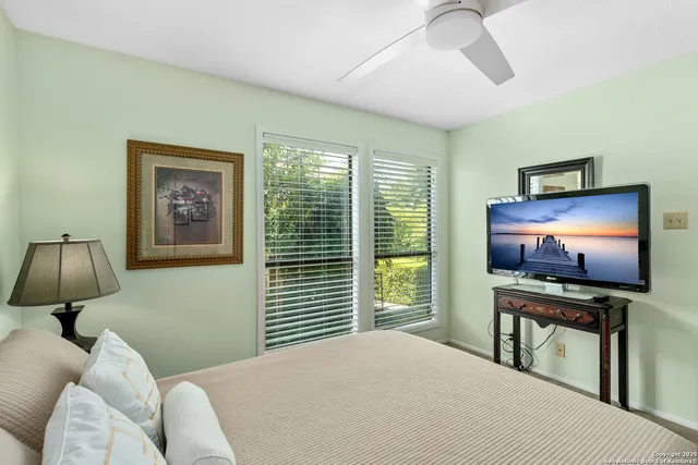 a bedroom with a bed and a flat screen tv