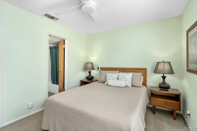 a bedroom with a bed and a night stand